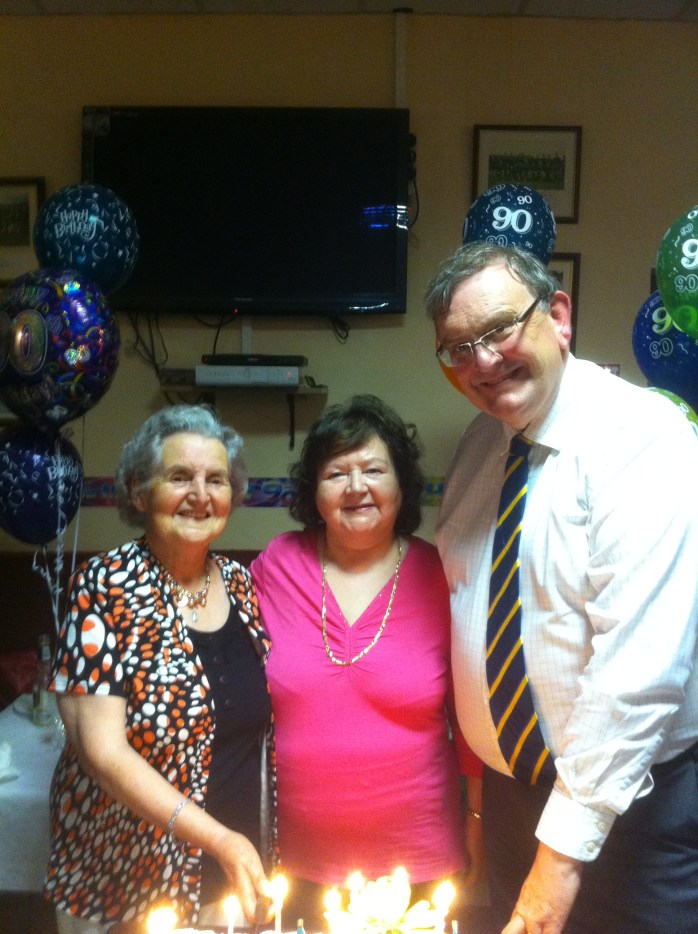 Helping to cut the birthday cake: with Bridie McGuire (left)