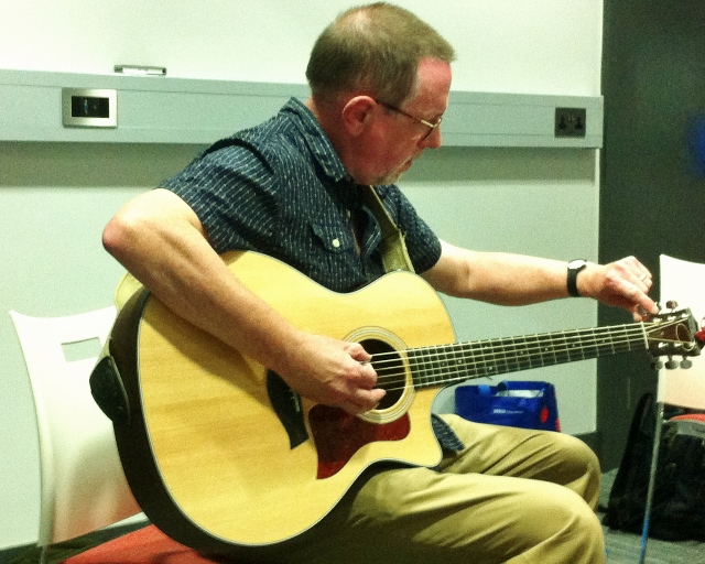 Stephen Hall tunes his guitar Photo: © Michael Fisher