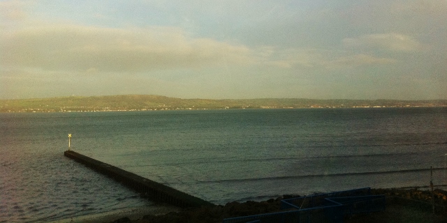 View from train of coastal path near Holywood   Photo: © Michael Fisher