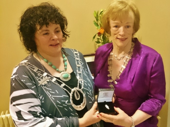 ICA National President Liz Wall presents Patricia Cavanagh with a silver oak leaf brooch to mark her three years as Monaghan Federation President Photo: © Michael Fisher