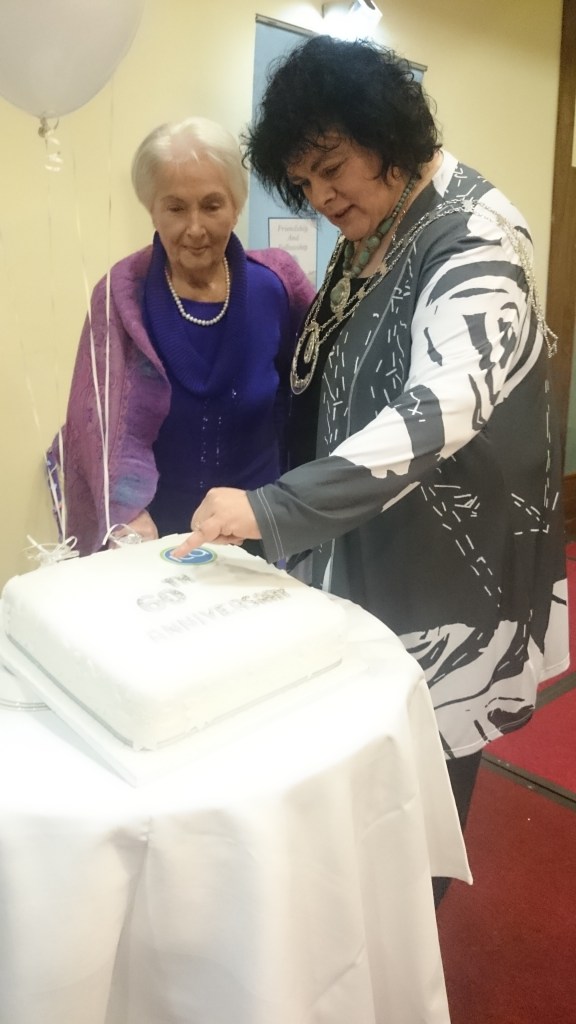 ICA National President Liz Wall cuts the 60th anniversary cake (by Mary Reilly Rockcorry) with one of her predecessors Mamo McDonald from Clones Photo: © Michael Fisher