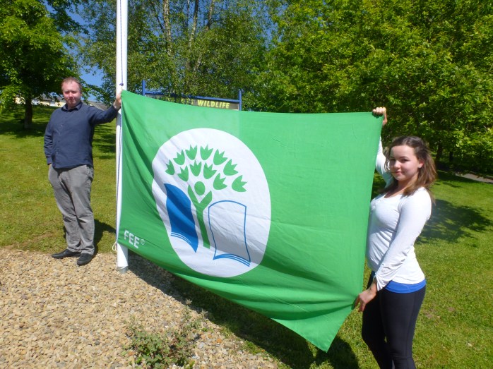 Past pupils Terry Cavanagh and Frances Treanor (Texaco Art Winner 2015) raising the second green flag at Tydavnet National School  Photo:  © Michael Fisher 