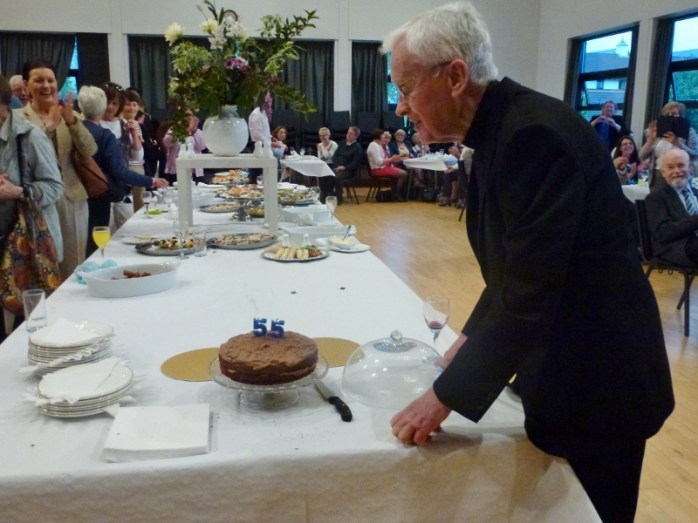 Blowing out the candles on the anniversary cake: Canon Brian McCluskey. Photo:  © Michael Fisher